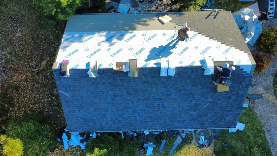 Aerial view of a large home's shingle roof captured during a drone survey