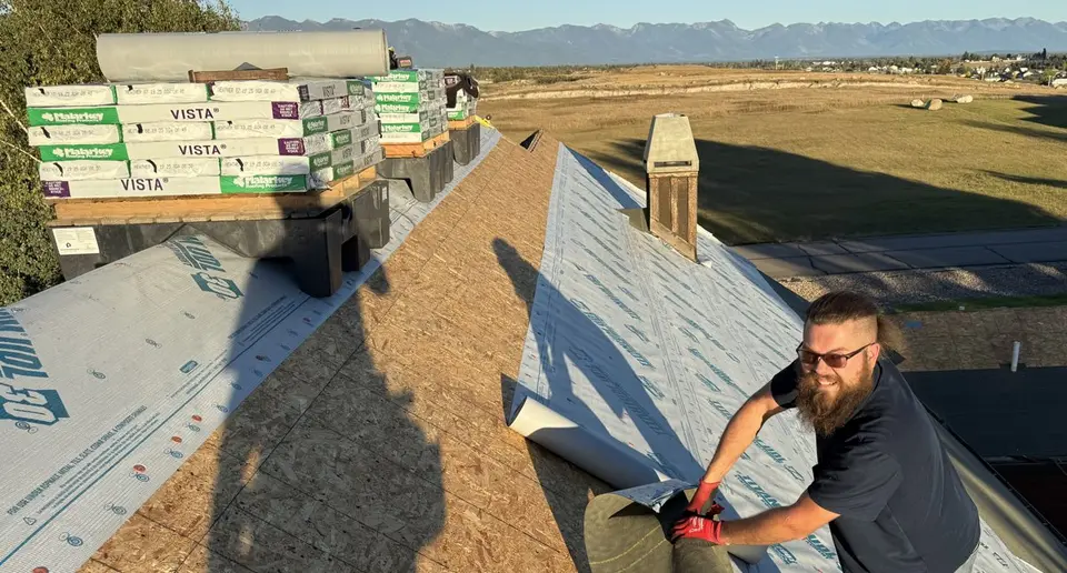 Sisu Roofing crew members working on an asphalt shingle roof