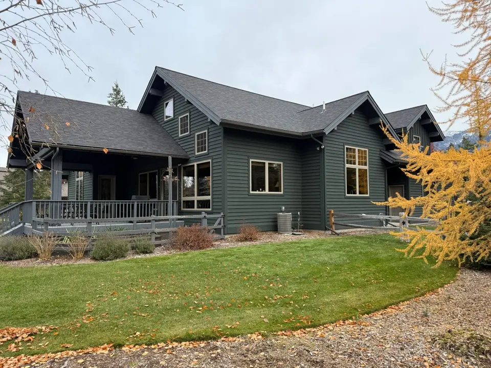 Home in the Flathead Valley with horizontal lap siding, white trim, and a shingle roof